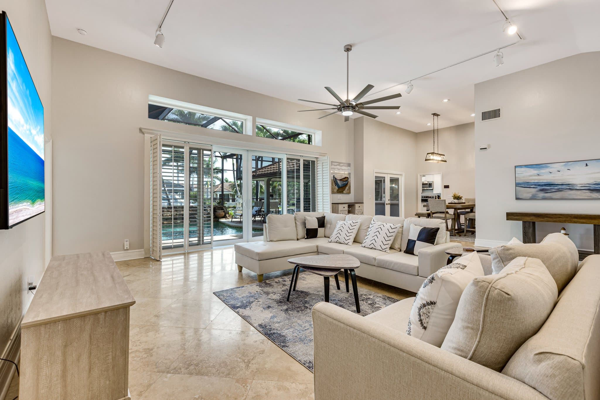 Living room with sliding doors opening to the pool deck