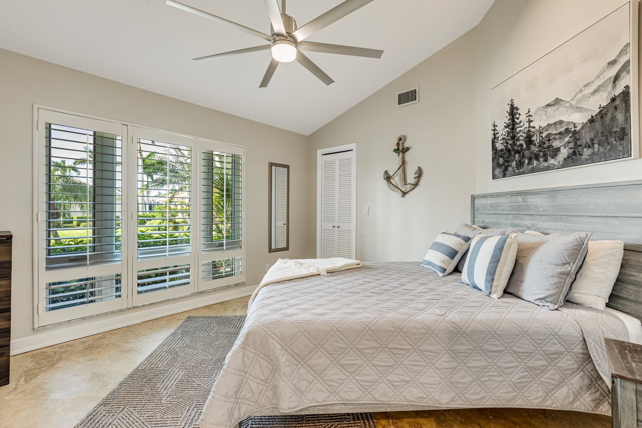 Second bedroom with king bed and plantation shutters
