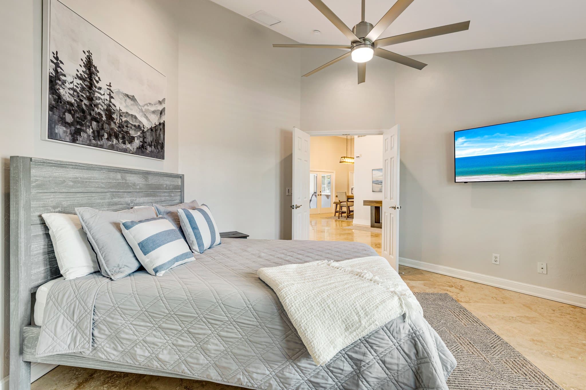Second bedroom with king bed and wall-mounted smart TV