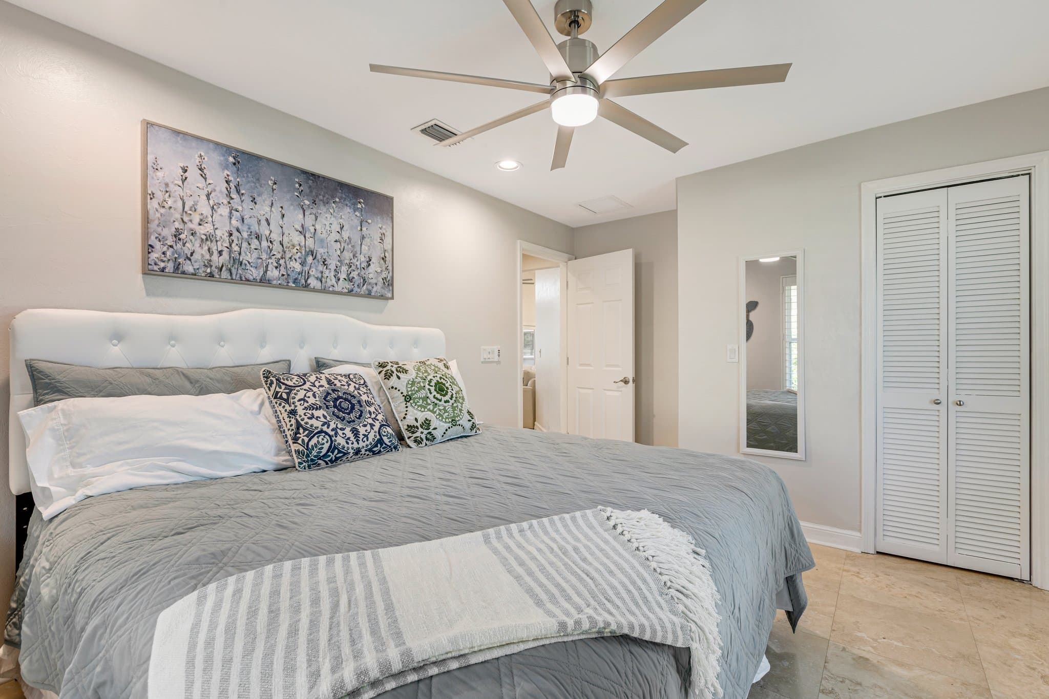 Third bedroom with upholstered headboard and closet
