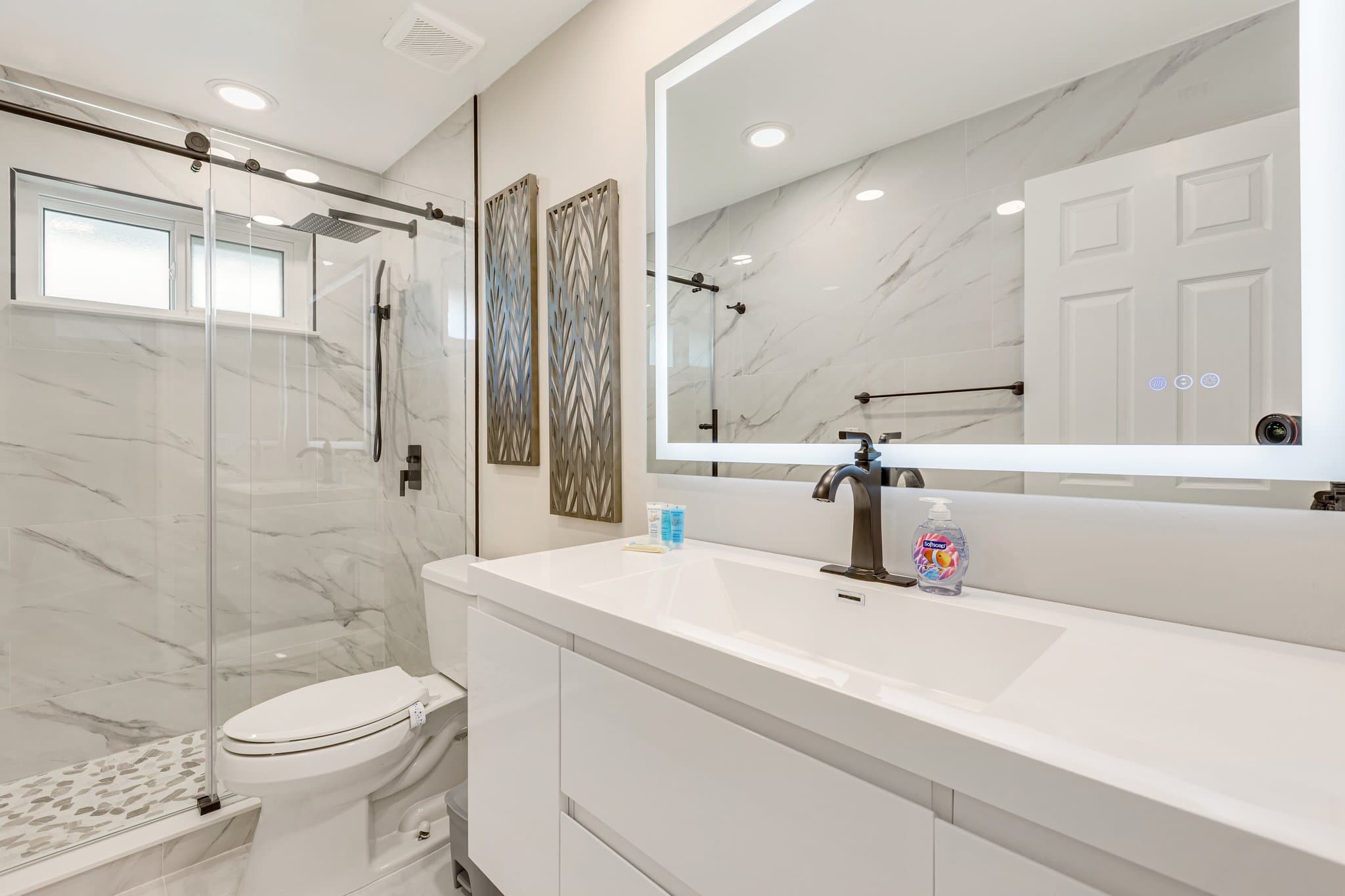 Shared full bathroom with glass walk-in shower