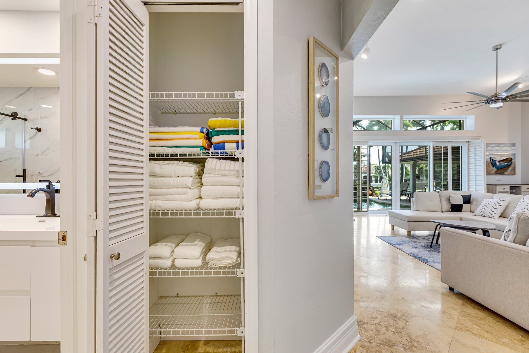 Linen closet stocked with bath and beach towels