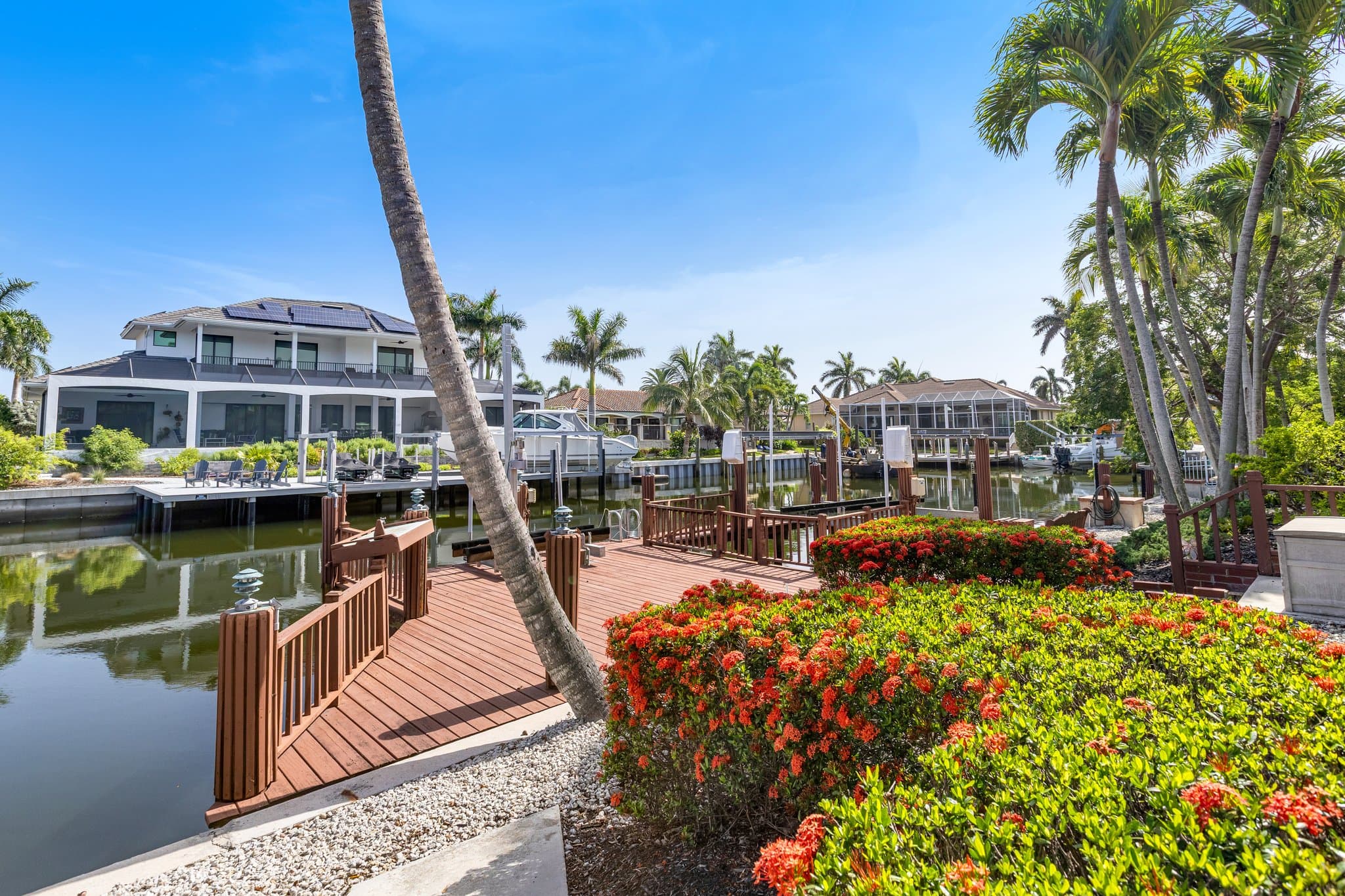 Private dock on the canal with tropical landscaping