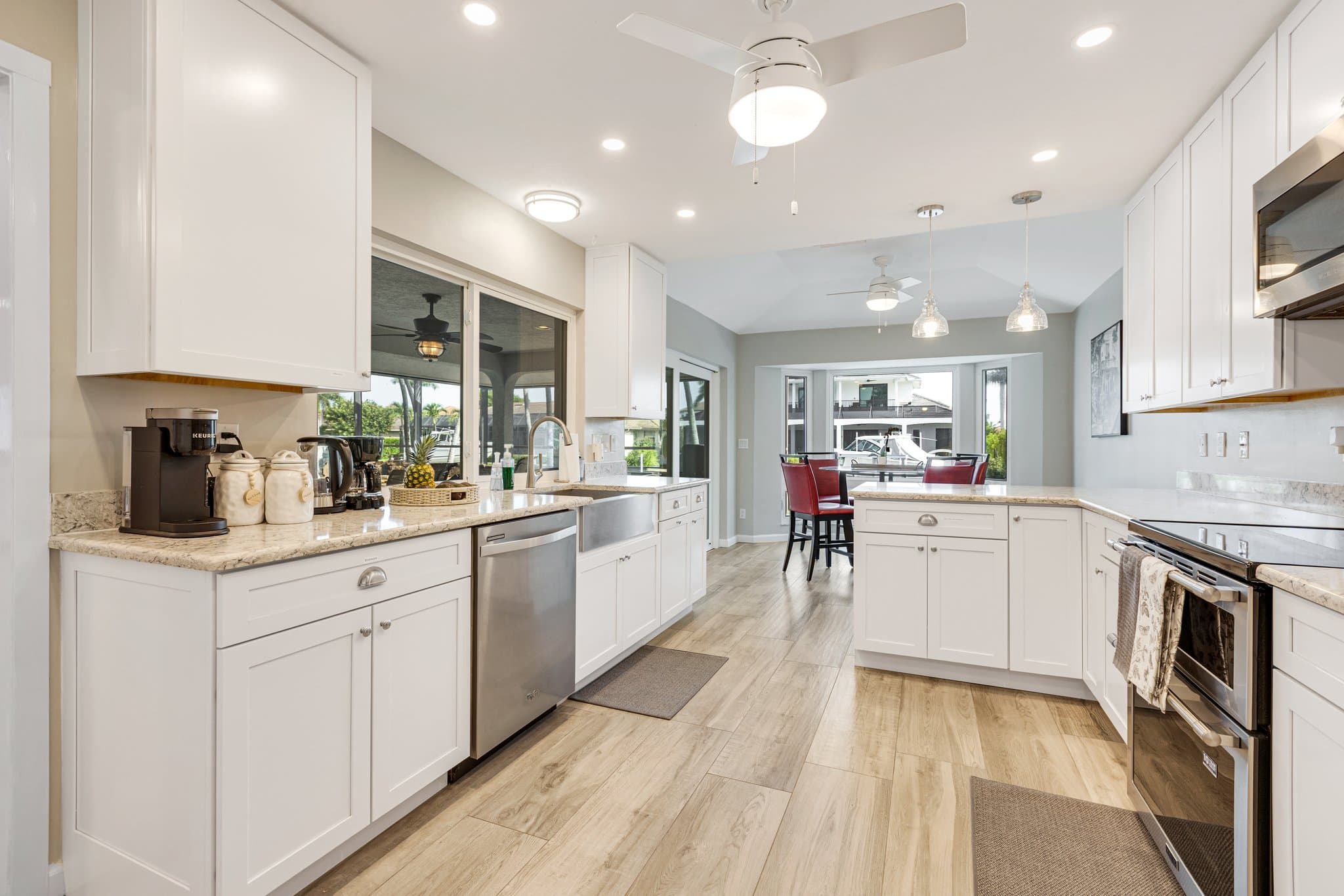 Kitchen with white cabinetry, granite counters and stainless appliances