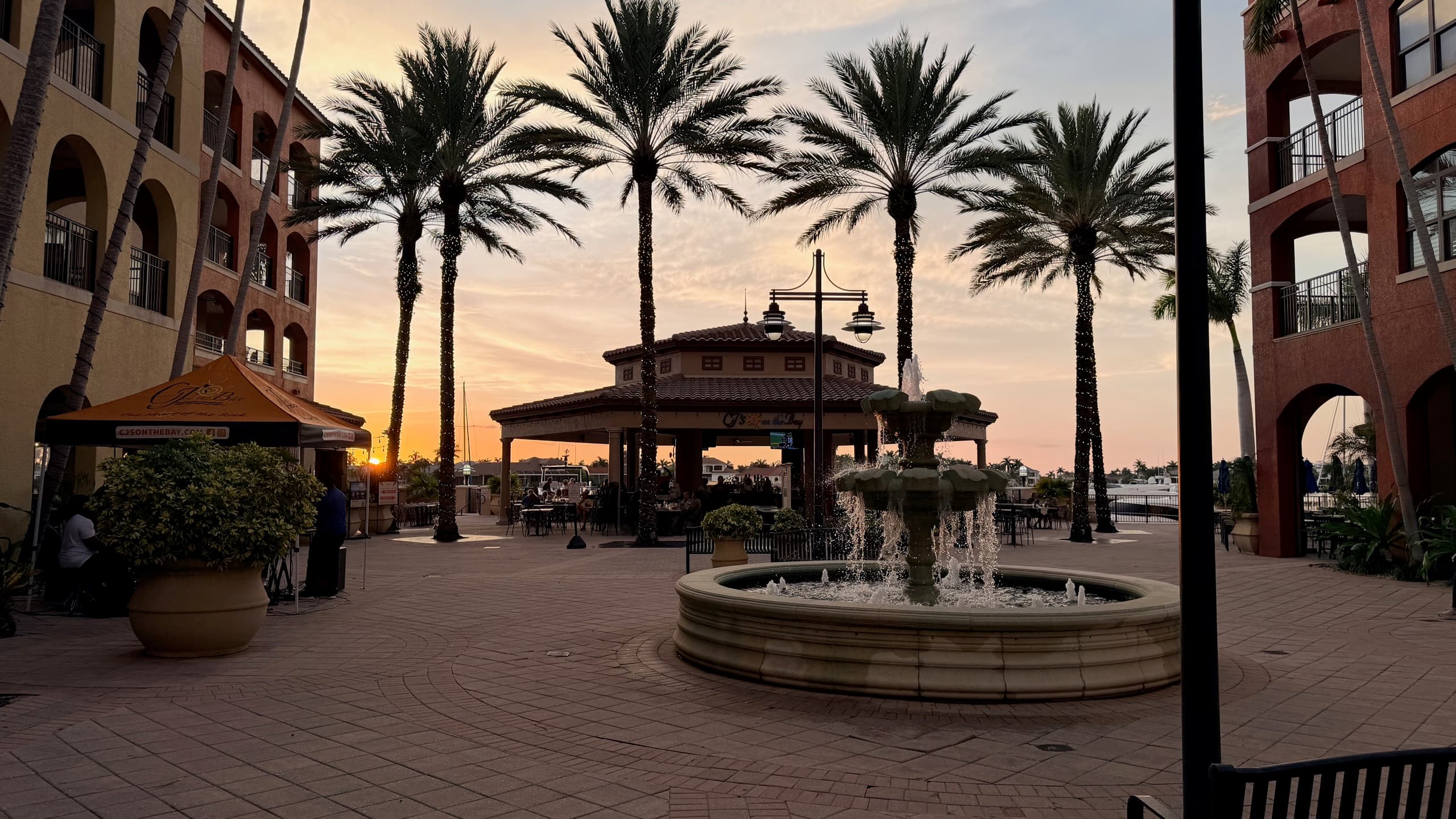 Esplanade marina on Marco Island at sunset, with waterfront shops and dining